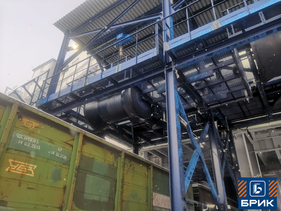 Установка уплотнения насыпного груза УНГ производства ТПК Брик — портальная конструкция с катком над железнодорожным путём